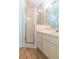 A bathroom featuring a walk-in shower, vanity, and wood-look flooring at 15814 Hampton Village Dr, Tampa, FL 33618