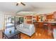 Bright living room with hardwood floors, bar seating, and sliding door access to a pool at 15814 Hampton Village Dr, Tampa, FL 33618