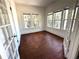 Sunlit room featuring hardwood floors, with natural light streaming through multiple windows at 160 16Th Ne Ave, St Petersburg, FL 33704
