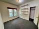 Bedroom with gray carpet, white walls, closet, window, and built-in shelving units at 160 16Th Ne Ave, St Petersburg, FL 33704