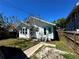 Charming home featuring white siding, aqua trim, mature trees, and a stepping stone path at 160 16Th Ne Ave, St Petersburg, FL 33704