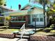 Charming two-story home featuring brick accents, a well-manicured lawn, and welcoming front steps at 160 16Th Ne Ave, St Petersburg, FL 33704