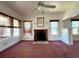 Inviting living room with a fireplace, built-in storage, and natural light from surrounding windows at 160 16Th Ne Ave, St Petersburg, FL 33704