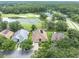 Aerial view of a home that backs onto a pond and the golf course with mature landscaping at 17503 Edinburgh Dr, Tampa, FL 33647