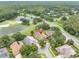 Stunning aerial view of a home nestled in a lush, green community near a pond and golf course at 17503 Edinburgh Dr, Tampa, FL 33647