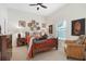 Cozy bedroom with hardwood bed frame, decorative accents, and a large window at 17503 Edinburgh Dr, Tampa, FL 33647