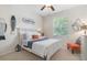 Bright bedroom with white furniture, beach decor, and a large window offering natural light at 17503 Edinburgh Dr, Tampa, FL 33647