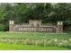 Hunter's Green neighborhood signage is surrounded by manicured flower beds and lawn at 17503 Edinburgh Dr, Tampa, FL 33647