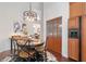 Dining area with hardwood floors, overhead lighting and a view to the kitchen at 17503 Edinburgh Dr, Tampa, FL 33647