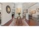Spacious entryway featuring hardwood floors, a decorative rug, and a view into the living and dining areas at 17503 Edinburgh Dr, Tampa, FL 33647