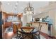 Kitchen with wooden cabinetry, a breakfast bar, and hardwood floors at 17503 Edinburgh Dr, Tampa, FL 33647