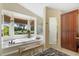 Bright main bathroom featuring a soaking tub, window views, and a glass shower stall at 17503 Edinburgh Dr, Tampa, FL 33647