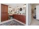 Well-lit main bathroom with double sink vanity, makeup vanity, and a door to the closet at 17503 Edinburgh Dr, Tampa, FL 33647