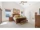 Bright main bedroom with high ceilings, two windows, and a doorway to the main bathroom at 17503 Edinburgh Dr, Tampa, FL 33647
