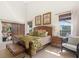 Bright main bedroom with high ceilings, two windows, and a doorway to the outdoor patio at 17503 Edinburgh Dr, Tampa, FL 33647