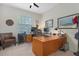 Spacious office featuring a large wooden desk, comfortable chair, and a window for natural light at 17503 Edinburgh Dr, Tampa, FL 33647