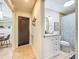 Hallway bathroom featuring a single vanity, toilet, and a shower with patterned curtain at 19032 Duncan Ct, Dade City, FL 33523