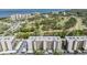 Aerial view of condominium buildings set among lush landscaping with a golf course and bay in the distance at 2700 Cove Cay Dr # 5-G, Clearwater, FL 33760