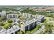 Expansive aerial view of condominium buildings interspersed with verdant landscapes, waterways, and residential zones at 2700 Cove Cay Dr # 5-G, Clearwater, FL 33760