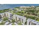 Aerial view of multiple condo buildings with lush landscaping, golf course, and bay views at 2700 Cove Cay Dr # 5-G, Clearwater, FL 33760