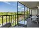 Outdoor balcony with seating area and screened in protection, offering scenic views of the surrounding landscape at 2700 Cove Cay Dr # 5-G, Clearwater, FL 33760