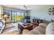 The cozy living room features a balcony offering scenic views of lush greenery and is perfect for enjoying the outdoors at 2700 Cove Cay Dr # 5-G, Clearwater, FL 33760