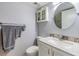 Bathroom featuring a vanity with marble countertop, decorative mirror, and toilet at 2700 Cove Cay Dr # 5-G, Clearwater, FL 33760