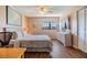 Bedroom with wood floors, fan, and a bright window at 2700 Cove Cay Dr # 5-G, Clearwater, FL 33760