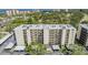Exterior view of a condominium building with well-maintained landscaping and covered parking in a lush green setting at 2700 Cove Cay Dr # 5-G, Clearwater, FL 33760