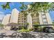 Building exterior with covered parking and well-manicured landscaping at 2700 Cove Cay Dr # 5-G, Clearwater, FL 33760