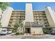 Building exterior with covered parking and well-manicured landscaping at 2700 Cove Cay Dr # 5-G, Clearwater, FL 33760