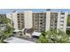 Multi-story condo complex featuring covered parking and beautifully landscaped surroundings at 2700 Cove Cay Dr # 5-G, Clearwater, FL 33760