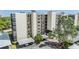 An exterior view of a multi-story residential building featuring a well-maintained facade and convenient covered parking at 2700 Cove Cay Dr # 5-G, Clearwater, FL 33760