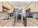 Spacious kitchen features stainless steel appliances, granite counters, and views to the dining area at 2700 Cove Cay Dr # 5-G, Clearwater, FL 33760