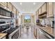 Bright kitchen features granite counters, stainless appliances, and a breakfast nook with balcony access at 2700 Cove Cay Dr # 5-G, Clearwater, FL 33760