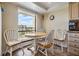 Cozy kitchen nook with a round table and chairs, next to a window and the kitchen at 2700 Cove Cay Dr # 5-G, Clearwater, FL 33760