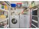 Functional laundry room with washer, dryer, storage shelves, and ample space for organizing household essentials at 2700 Cove Cay Dr # 5-G, Clearwater, FL 33760
