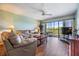 Comfortable living room with sliding glass doors to the balcony that offers lots of light, and a leather sofa at 2700 Cove Cay Dr # 5-G, Clearwater, FL 33760