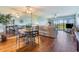 Open-concept living room with hardwood floors, ceiling fans and access to the balcony at 2700 Cove Cay Dr # 5-G, Clearwater, FL 33760