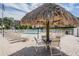 Charming pool area with shaded seating under a thatched umbrella at 2700 Cove Cay Dr # 5-G, Clearwater, FL 33760