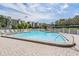 The clear blue community pool is surrounded by a brick patio at 2700 Cove Cay Dr # 5-G, Clearwater, FL 33760