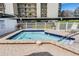 Inviting hot tub spa with paved patio, steps, and safety rails at 2700 Cove Cay Dr # 5-G, Clearwater, FL 33760