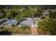Aerial shot of a charming single-Gathering home with mature landscaping, a front porch, and a long driveway at 2736 45Th N Way, St Petersburg, FL 33713