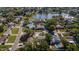Scenic aerial view of the neighborhood, featuring lush greenery, a tranquil lake, and well-maintained homes at 2736 45Th N Way, St Petersburg, FL 33713
