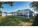 Large fenced-in backyard featuring a screened-in pool, storage shed, and plenty of green space at 2736 45Th N Way, St Petersburg, FL 33713
