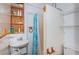 Basement bathroom with a sink, toilet, and an enclosed shower with curtain at 2736 45Th N Way, St Petersburg, FL 33713
