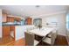 Bright dining area with hardwood flooring and a marble table adjoins an open kitchen at 2736 45Th N Way, St Petersburg, FL 33713