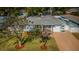Aerial view of a blue, single-story home featuring a well-kept lawn and mature trees at 2736 45Th N Way, St Petersburg, FL 33713