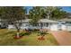 Charming single-story home with a well-manicured lawn and mature trees providing shade and curb appeal at 2736 45Th N Way, St Petersburg, FL 33713