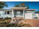 Charming single-story home featuring a covered porch, light blue paint, and a well-maintained front lawn at 2736 45Th N Way, St Petersburg, FL 33713
